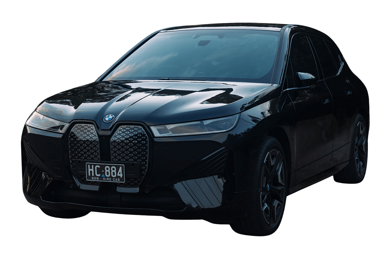 A black BMW iX electric SUV with a glossy finish and a visible "HC·884" hire car license plate, photographed on a transparent background.